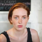 About 6 a woman looking at the camera