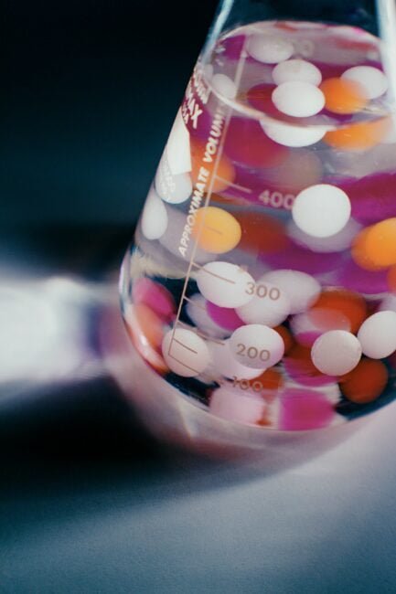About 1 a beaker with colorful balls in it