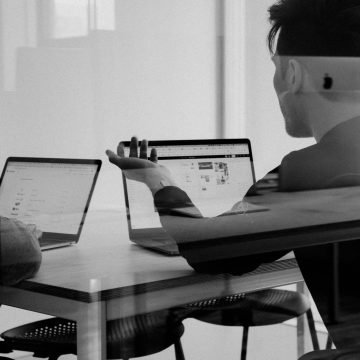 a man sitting at a table with a laptop